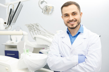 Handsome male professional dentist at his office - obrazy, fototapety, plakaty