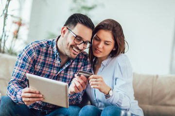 Young couple shopping on internet with tablet