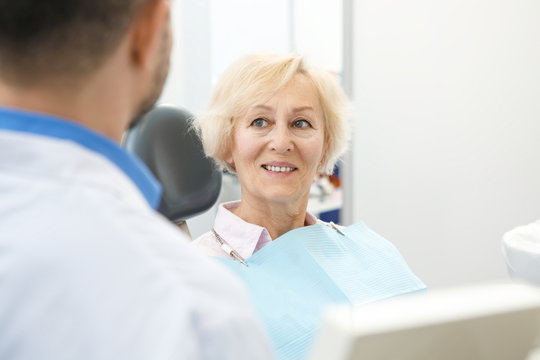 Professional Dentist And His Senior Patient