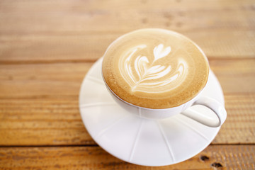 Cup of coffee with latte art pattern milk foam