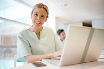 Nurse smiling at camera in hospital office