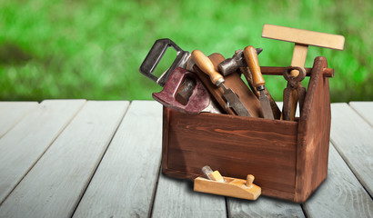 Tools on wooden table in the summer garden on a sunny day