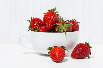 cup of fresh strawberries on a white background, closeup