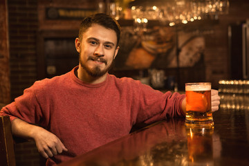 Young man relaxing at the pub having beer