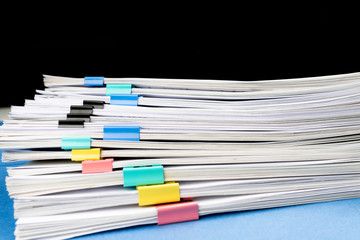 Mock up, stack of papers documents in archives files with paper clips on desk at offices, business concept. Copy space.