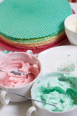 Cream of different colors for decorating waffle cake. Round wafer cakes of different colors. For making waffle cake.