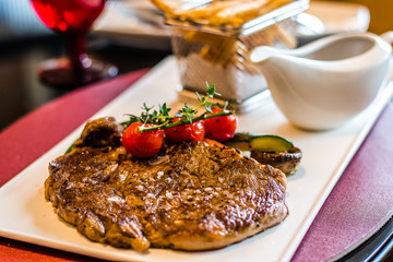 L’Entrecote de Boeuf 200 days grain fed Angus rib eye with a dense brandy cream sauce and crispy fries.