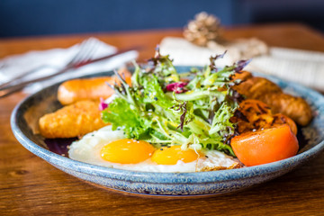 Big breakfast set with chicken ham, jumbo beef sausage, croissant, hashbrown, sunny side up egg, grilled tomato