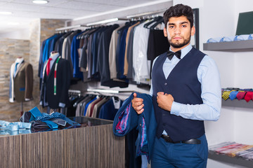 Fototapeta premium Customer man is demonstrating image in waistcoat with butterfly