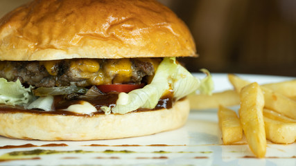 Beef burger and french fries appetizing.