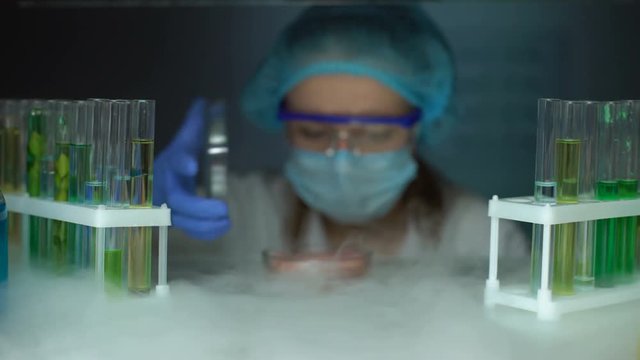 Scientist taking meat sample in petri dish from fridge, infected tissue analysis