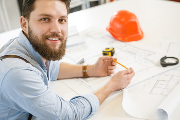 Young male architect working at his office