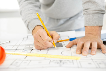 Young male architect working at his office