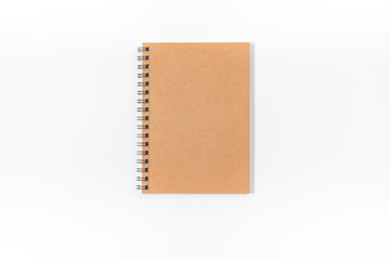 Brown spiral notebook isolated on white background.top view