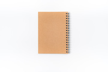 Brown spiral notebook isolated on white background.top view
