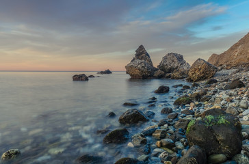 Nerja, Malaga, Andalusi, Spain - February 7, 2019: Playa del Molino, small stone beach with three large rocks on the shore, Nerja, southern Spain