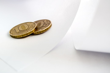 twenty rubles two coins on white paper, paper bends and copper