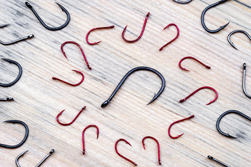 big fishing hook in the center of the black color of, and around him red hooks around the circle are shelved