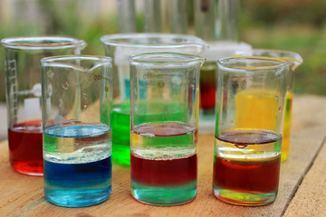 Multilayer colored substances are in three beakers.