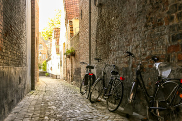 Typical Belgian street and parked bicycles on foreground