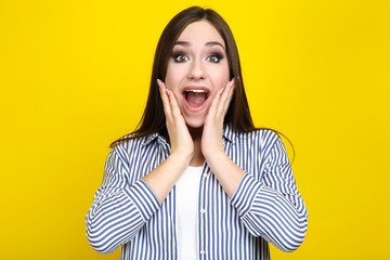 Beautiful young woman on yellow background