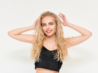 Photo of blond female model with white teeth looking at camera and smiling. Isolated on a white background