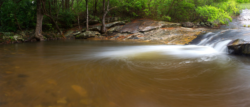 River flowing over rocks and the Debengeni Waterfall