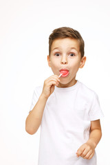 little boy with a lollipop on a white background 