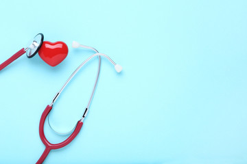 Stethoscope with red heart on blue background