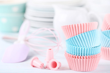 Colorful cupcake cases with kitchen utensils