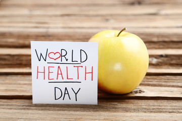 Text World Health Day with apple fruit on brown wooden table
