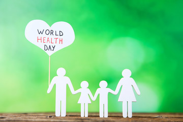 Text World Health Day with family figure on green background