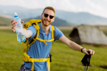 Naklejka premium Handsome young red hair hiking man