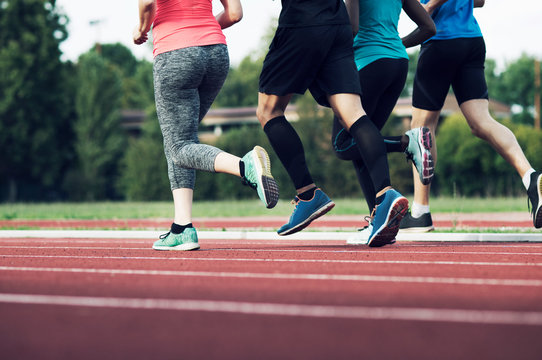Low section of runners practicing on track