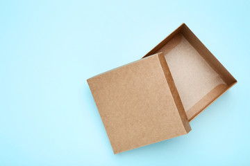 Open brown gift box on blue background