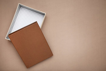 Fototapeta premium Open gift box on brown background