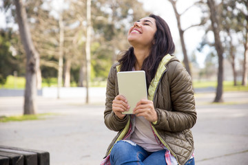 Ecstatic girl with tablet excited about good news