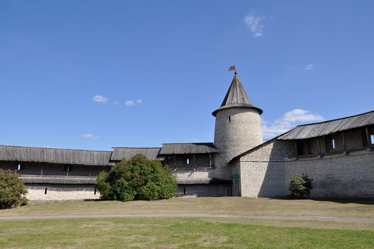 Veche Square of the Pskov Kremlin with a view of the Clock Tower and fortress walls, Russia.