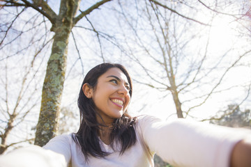Cheerful excited girl picturing herself outdoors