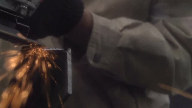 Angle Grinder. Tool on metal grind metal product. Sparks fly directly into the lens. Slow Motion at a rate of 240 fps