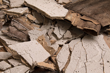 Pieces of broken stucco caused by water damage
