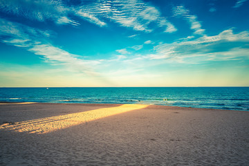 Fototapeta premium beam of light on sand of the beach at sunset