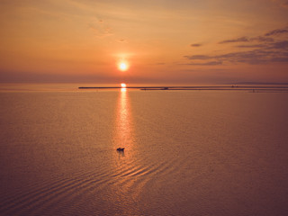 Beautiful aerial natural sunrise with boat at sea