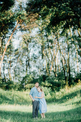 Happy young family spending time together outside in green nature