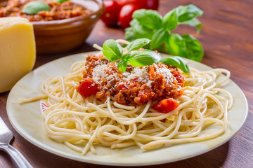 Spaghetti Bolognese with cheese and basil