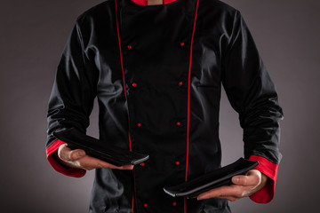 Closeup of chef holding empty plates.