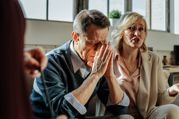 Distressed old man being depressed with situation in his family