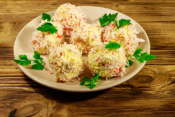 Appetizer of crab-cheese balls on wooden table