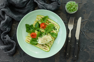 Salad from zucchini slices with cherry tomato, cream cheese and micro greens. Vegetarian food