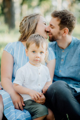 Fototapeta premium Happy young family spending time together outside in green nature